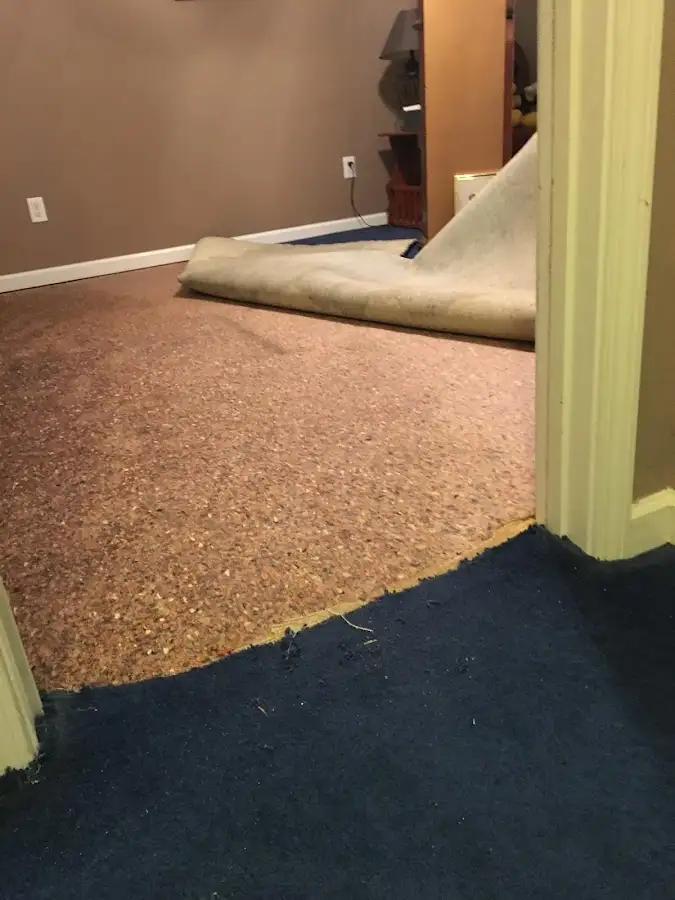 Carpet pad removal revealing water damage during Water Mitigation Services in North Auburn