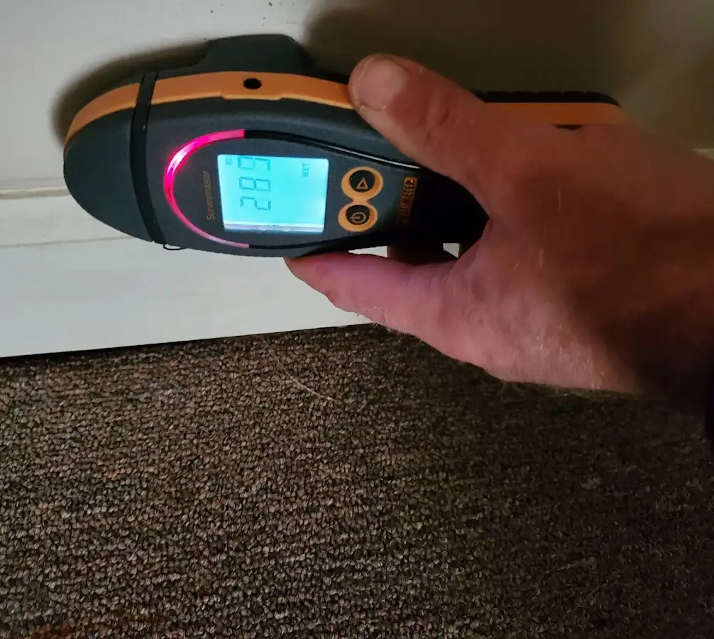 Moisture detection at baseboard during Storm Damage Restoration in North Auburn